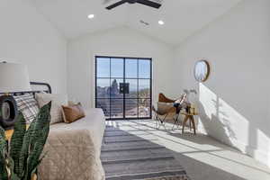 Bedroom with carpet, vaulted ceiling, ceiling fan, and access to exterior