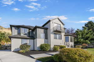 View of side of property with a balcony