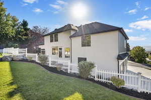 Rear view of house featuring a lawn