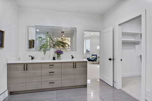 Bathroom featuring tile patterned flooring and vanity