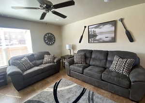 Tiled living room featuring ceiling fan and a healthy amount of sunlight