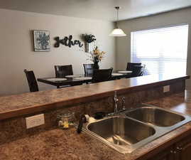 Kitchen with hanging light fixtures and sink