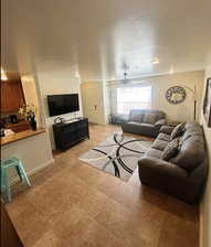 Tiled living room featuring ceiling fan