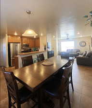 Dining room featuring ceiling fan and light tile patterned floors