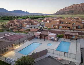 View of pool with a mountain view and a patio area