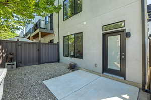 Fenced in patio area with solar lighting, concrete pad and 3/4" rock.