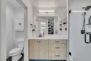 Full bath featuring a stall shower, vanity, and a walk in closet. Too many upgrades to list!