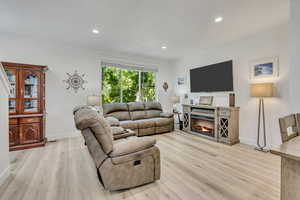 Living area featuring LVP flooring 9"x6" planks, recessed lighting and lots of natural lighting