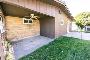 Property entrance featuring a lawn, ceiling fan, and a patio area