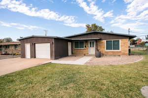 Single story home with a front lawn and a garage