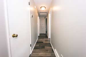 Hall featuring dark LVP flooring