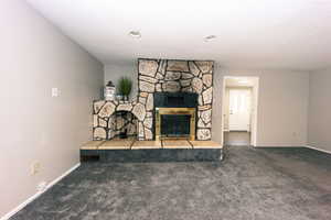 Close-up of the pretty fireplace with storage for wood.  Cuddle-up winter is coming. The Door to the right leads to the utility room out to the back-covered patio.