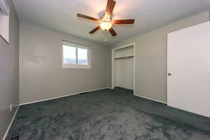 Bedroom #1 view one with pretty gray carpet, ceiling fan, and a closet