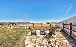 View of patio / terrace featuring a rural view, a mountain view, and a fire pit