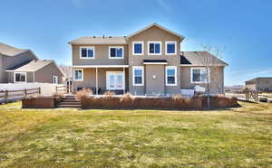 Rear view of house featuring a yard