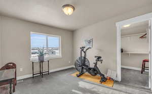 Exercise room featuring dark carpet