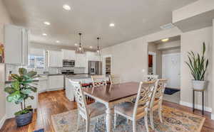 Dining space with light hardwood / wood-style flooring