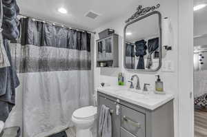 Bathroom featuring walk in shower, vanity, hardwood / wood-style floors