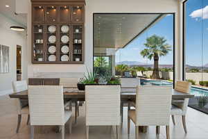 Dining area featuring a wealth of natural light, a mountain view, and light tile patterned floors