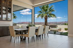 Dining space with a mountain view and light tile patterned floors