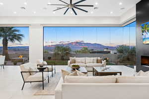 Living room featuring a mountain view, ceiling fan, and light tile patterned floors