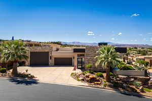 Adobe home featuring a mountain view and a garage