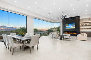 Dining space featuring a fireplace and light tile patterned floors