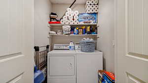 Washroom featuring washing machine and dryer