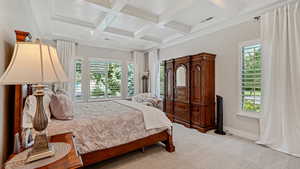 Master Carpeted bedroom featuring ornamental molding, coffered ceiling, and coffered ceiling