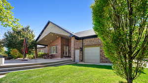 View of back of property with a garage entrance