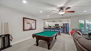 Game room featuring pool table, a textured ceiling, ceiling fan, and light colored carpet