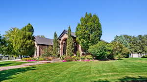 View of front facade with a garage and a front lawn