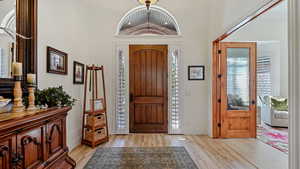 Entryway featuring light hardwood / wood-style floors and vaulted ceiling