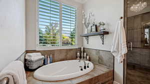 Master Bathroom featuring independent shower and bath and plenty of natural light