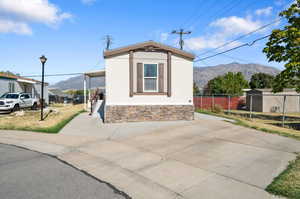 View of side of home with a mountain view