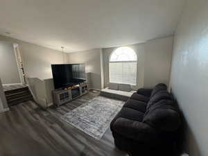 Living room with dark hardwood / wood-style flooring