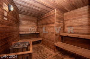 View of sauna featuring wood ceiling, wooden walls, and hardwood / wood-style flooring