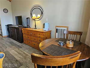 Dining space with hardwood / wood-style floors