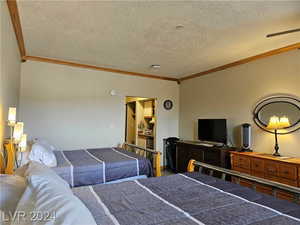 Bedroom with a textured ceiling and ornamental molding