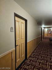 Hallway featuring a textured ceiling