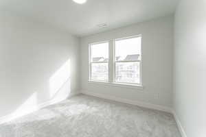 Carpeted empty room featuring a textured ceiling