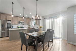 Dining area with a notable chandelie,