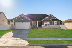 Craftsman house featuring a front yard and a garage. Photoshopped with grass