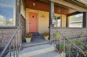 Doorway to property featuring covered porch