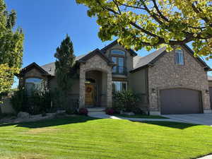 French provincial home featuring a front yard