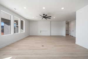 Spare room featuring ceiling fan and light hardwood / wood-style flooring