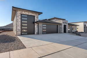 View of front of property with a mountain view and a garage