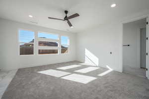 Empty room with light carpet and ceiling fan