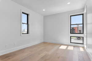 Unfurnished room featuring light wood-type flooring