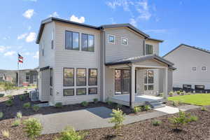 Rear view of house featuring a patio and central AC